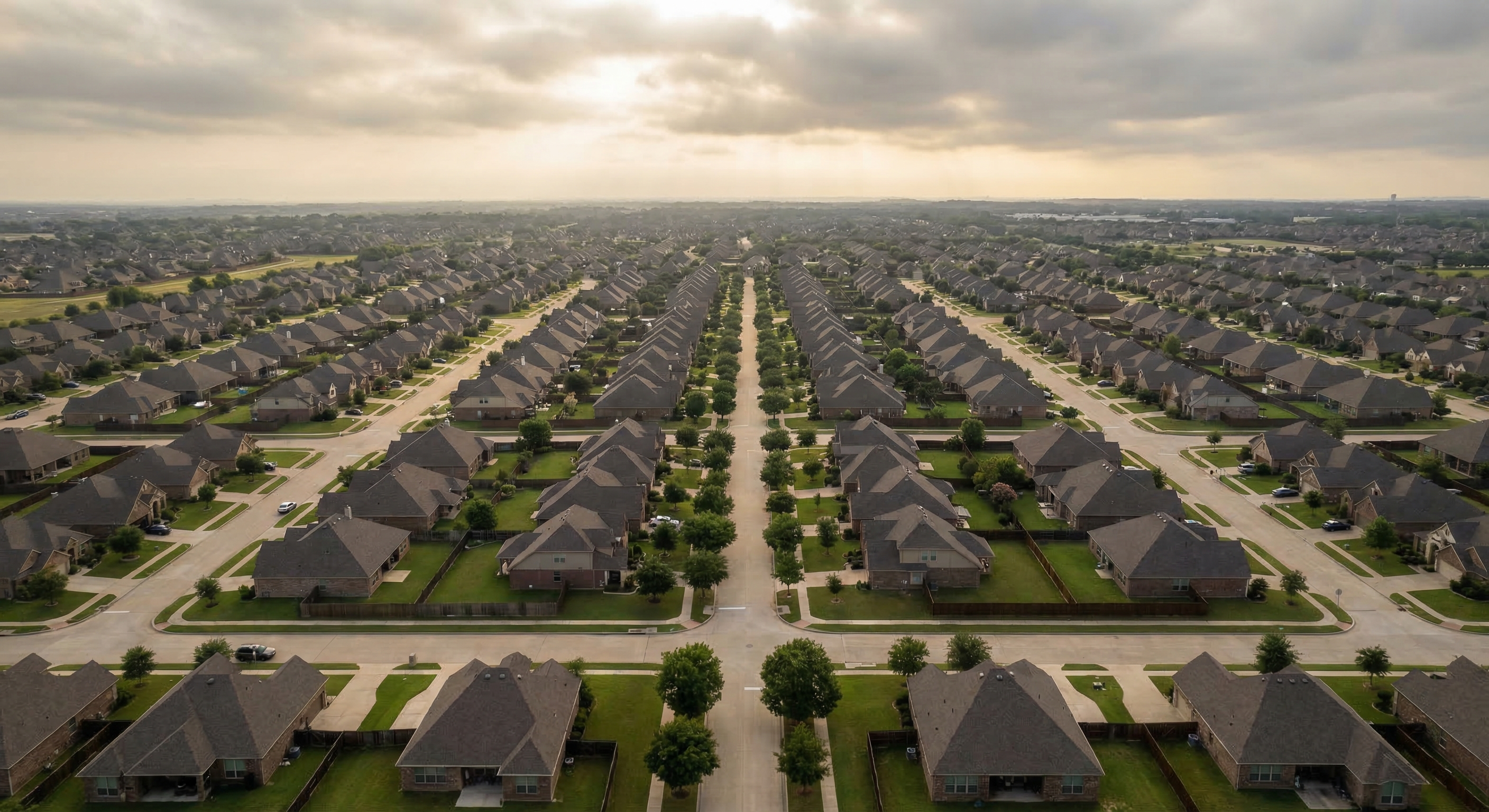 Aerial view of a uniform American suburban residential neighborhood showing rows of single-family homes